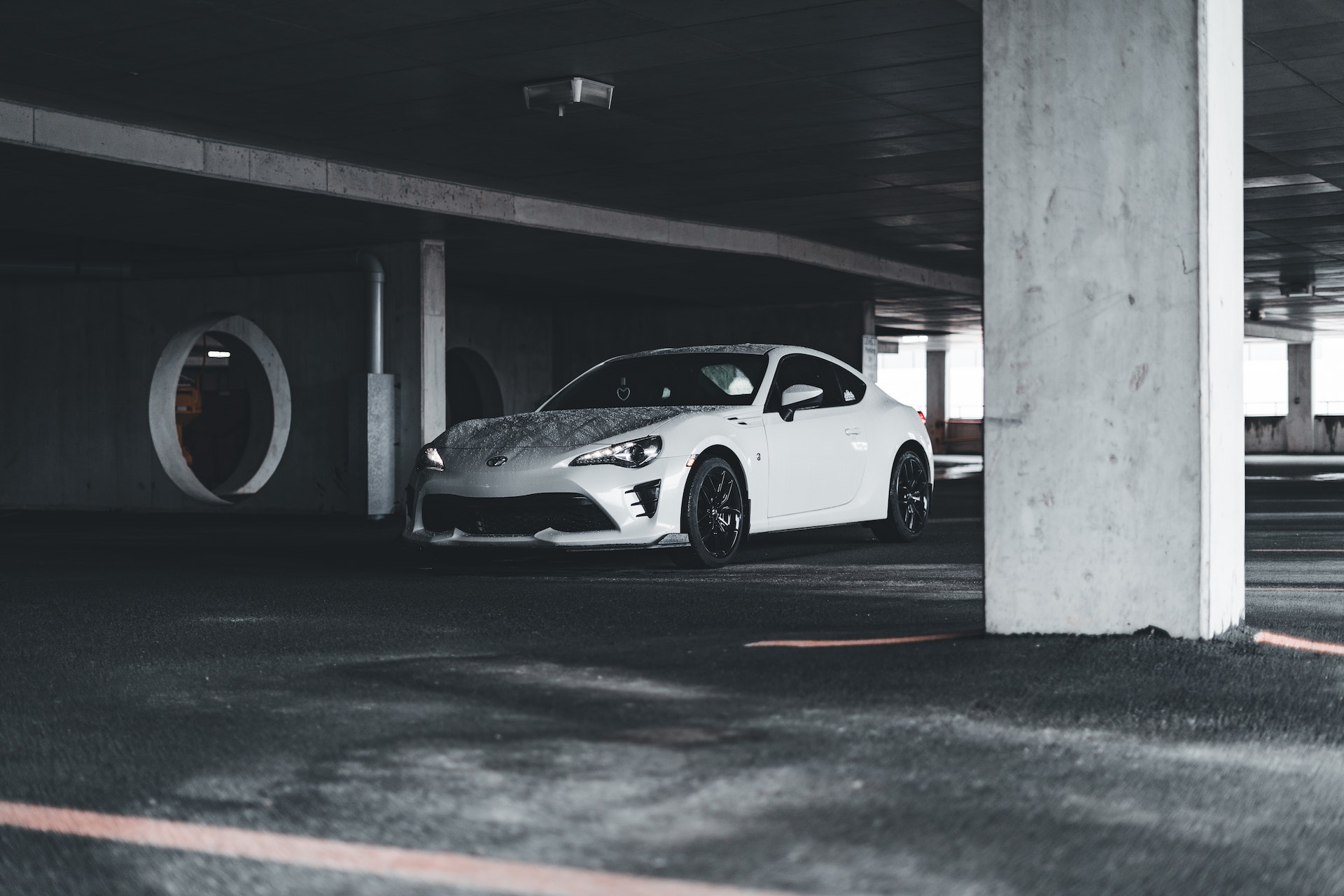 Toyota di colore bianco in un parcheggio coperto